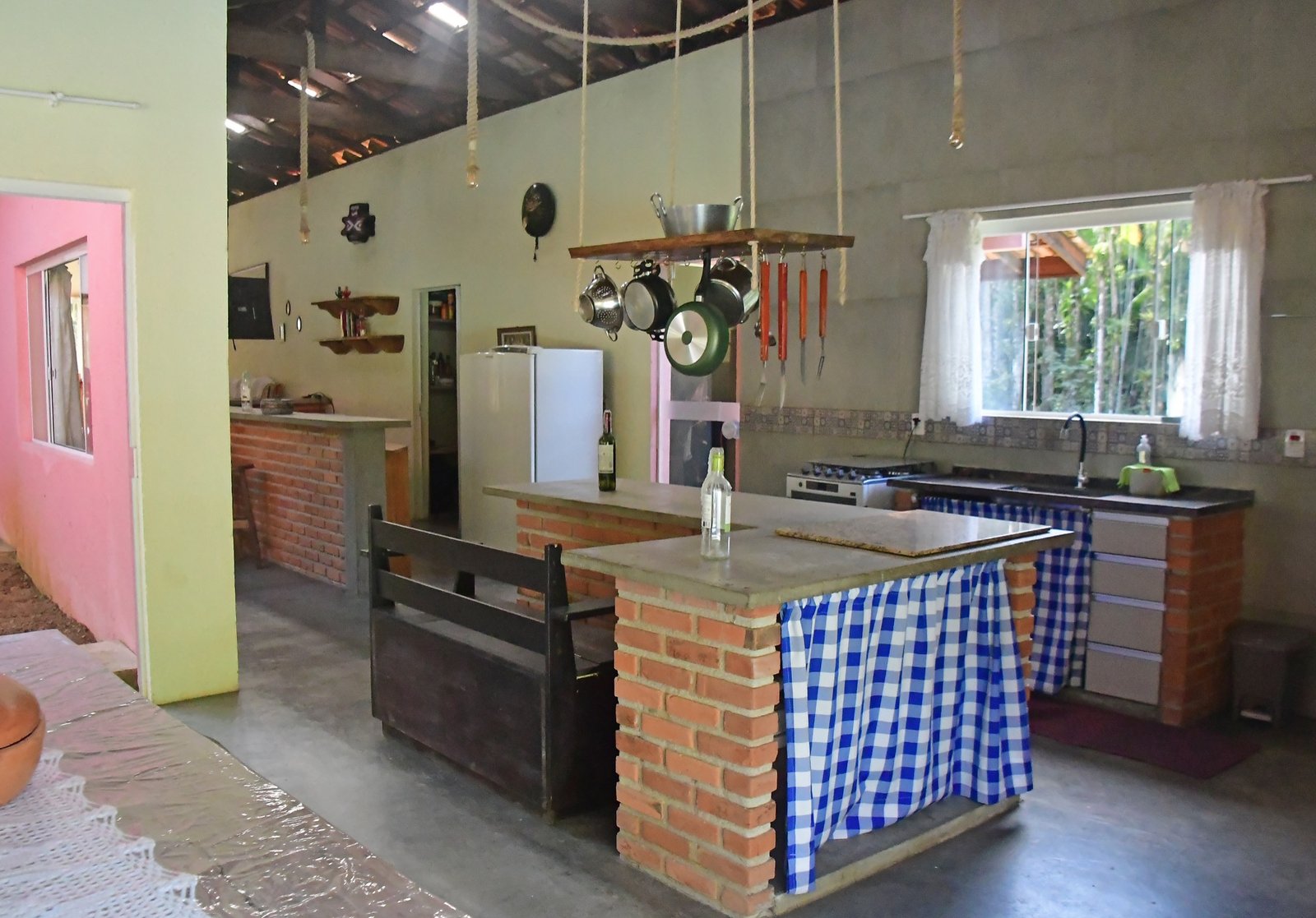 Cozinha gourmet com bancada de tijolos e utensílios